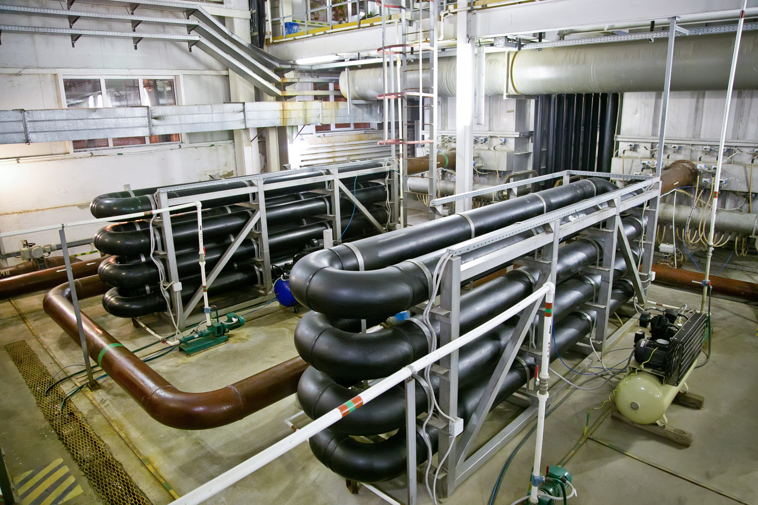 Pipes and sewage pumps inside modern industrial wastewater treatment plant